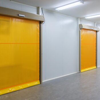 Roller shutter door and concrete floor inside factory building for industrial background.