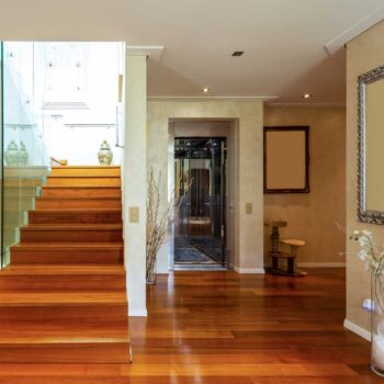 Entry with stairs and glass, parquet. No one inside
