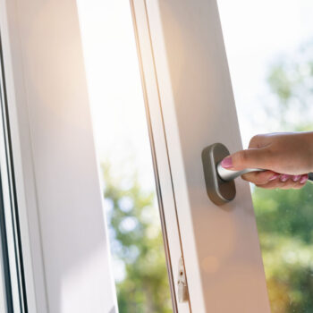 hand open white plastic pvc window at home